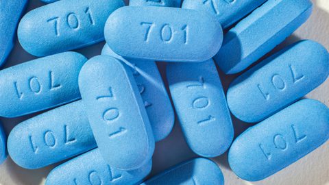 Close-up of a pile of blue PrEP pills marked "701".