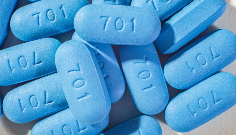 Close-up of a pile of blue PrEP pills marked "701".