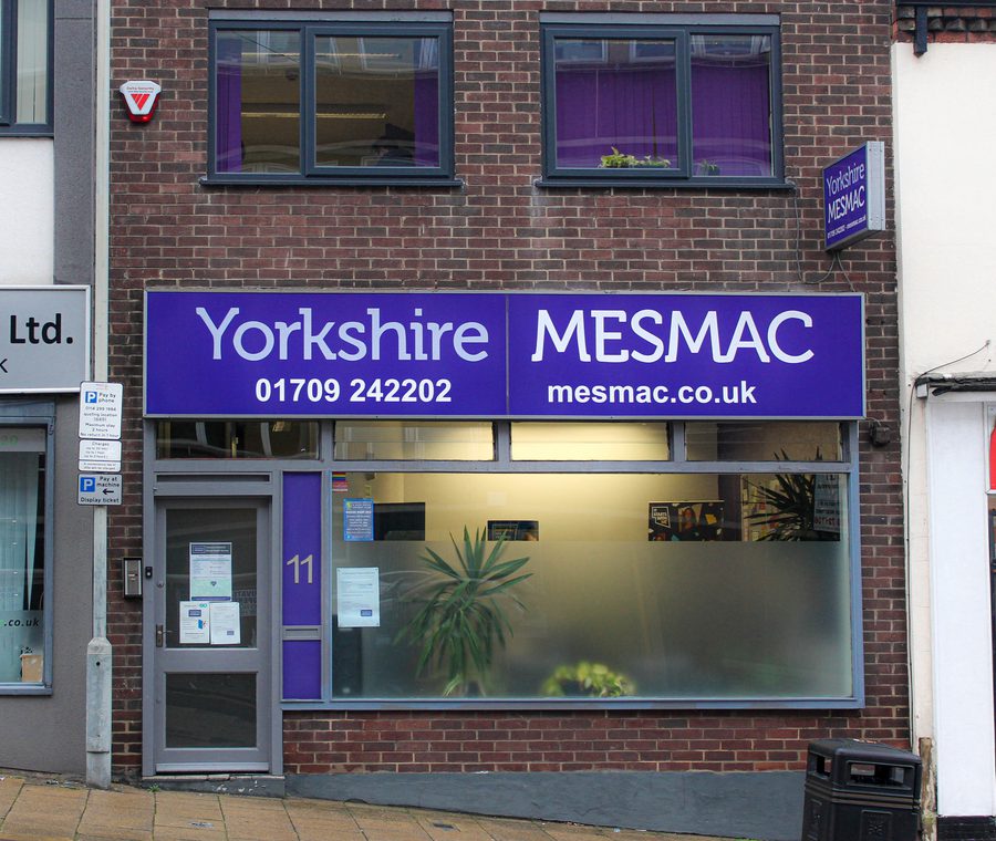The Yorkshire MESMAC Rotherham office shopfront with a purple sign and a numbered door.