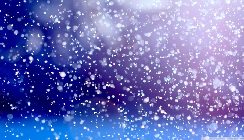 Falling snow against a deep blue and purple background.